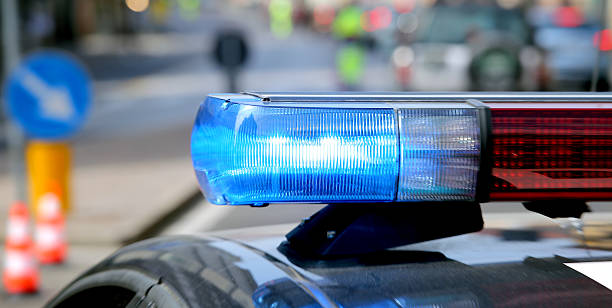 istock blue flashing police car during a roadblock 528631372