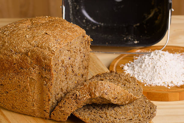 istock Fresh cutted loaf of rye bread and some flour on 528631447