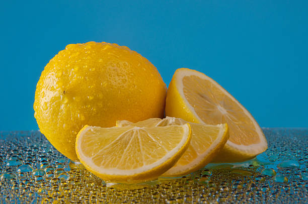 istock Lemons with drops of water on a blue background 528631892