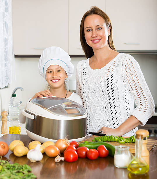 istock Girl and her mom with rice cooker 528632859