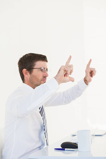 istock Businessman holding hands up at desk 528633117