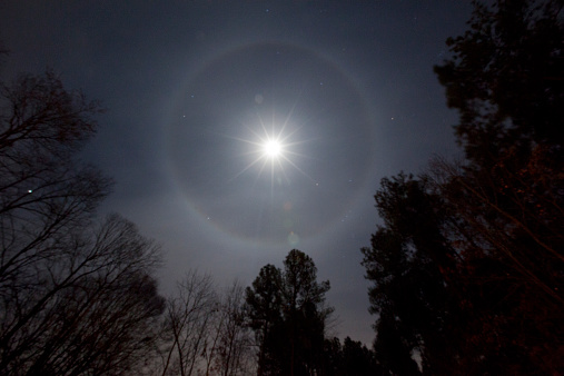 A Lunar halo phenomenon around full moon which is formed by moonlight passing through ice crystals in the atmosphere.