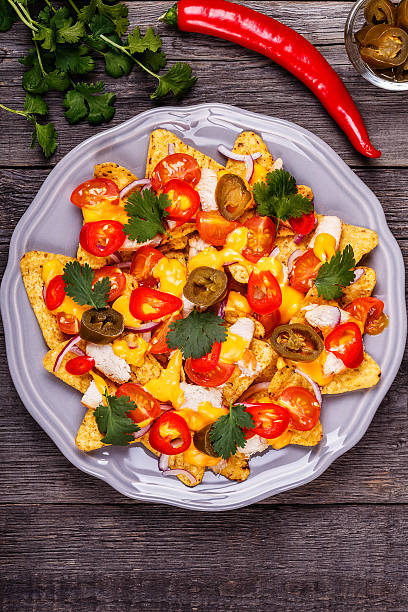 istock Nachos with melted cheese sauce, jalapeno, chicken, vegetables. 528635428