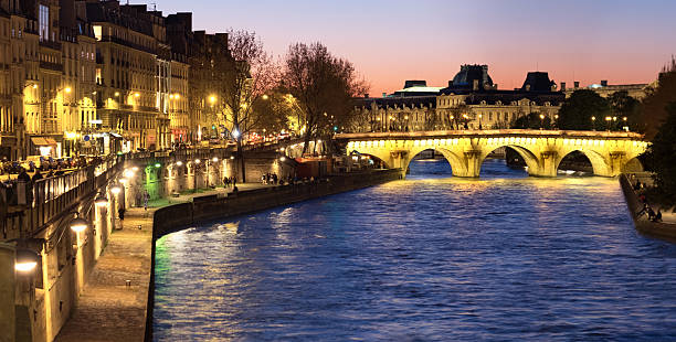istock Paris, panorama along Seine river towards illuminated Pont Neuf 528636178
