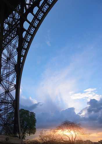 Paris romantic background with glorious sunset framed with the side of Eiffel Tower. Space for your text.