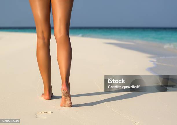 Beach Travel Woman Walking On Sand Beach Leaving Footprints Stock Photo - Download Image Now