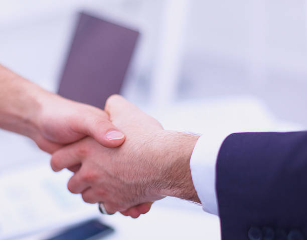 istock Businessmen shaking hands, isolated on white. 528636587