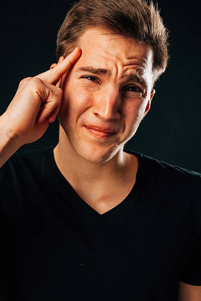 istock Handsome young man suffering because of headache. Black background 528636706