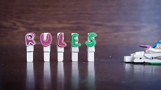 Photo of RULES word on clothes peg stick