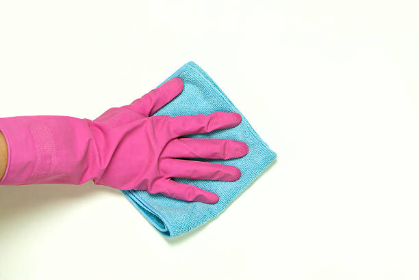 istock One hand in pink rubber gloves 528684267