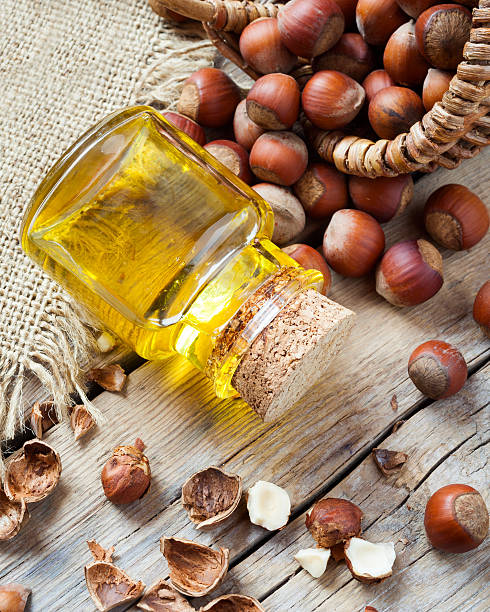istock Bottle of nut oil and basket with hazelnuts 528684347