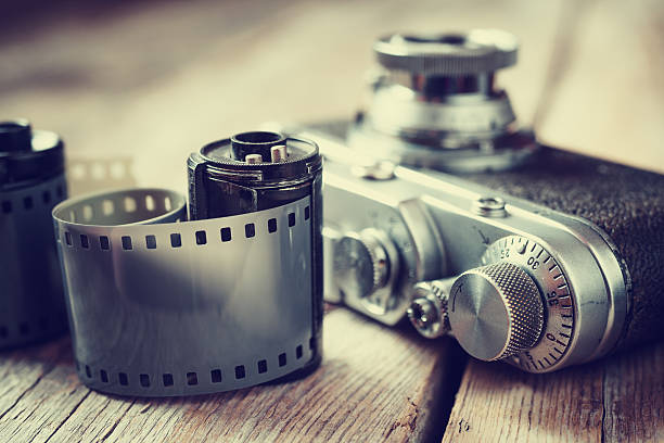 Old photo film rolls, cassette and retro camera, selective focus Old photo film rolls, cassette and retro camera, selective focus. Vintage stylized. darkroom photos stock pictures, royalty-free photos & images