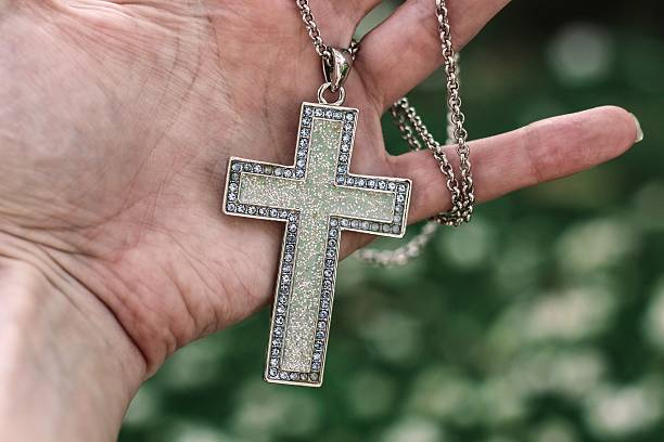 istock Sparkly vintage cross in a woman's palm 528707505