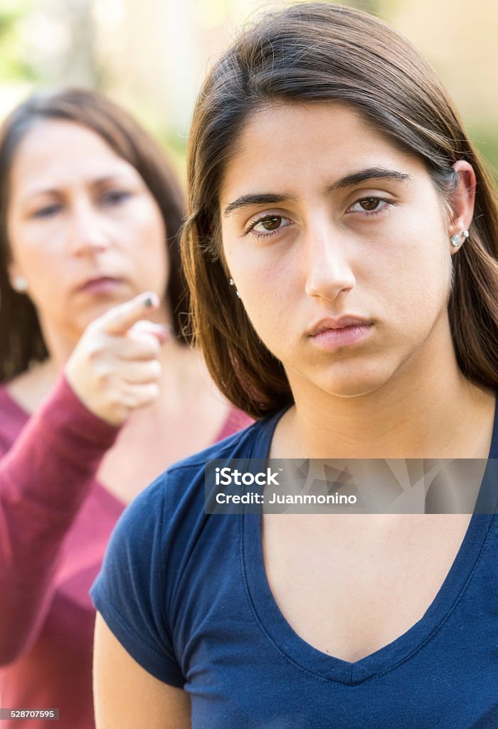 mother scolding her daughter hispanic mother scolding her teenage daughter Parent Stock Photo