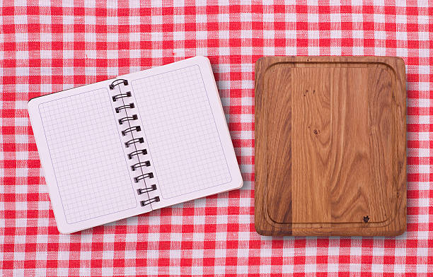 istock Pure notebook for recording menu, recipe on tablecloth tartan. 528708499
