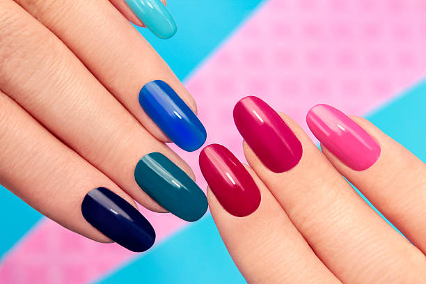 Blue pink manicure. Blue pink nail Polish on long nails on a colored background. fingernail stock pictures, royalty-free photos & images