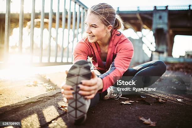 Athlete Stretching At Portland Waterfront Stock Photo - Download Image Now - Running, Women, Stretching
