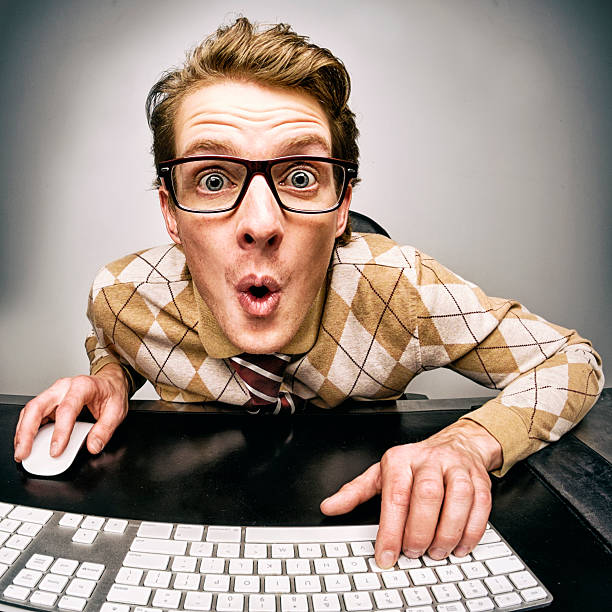 Funny Nerdy Guy A funny nerdy guy working at his computer. mesmerised stock pictures, royalty-free photos & images