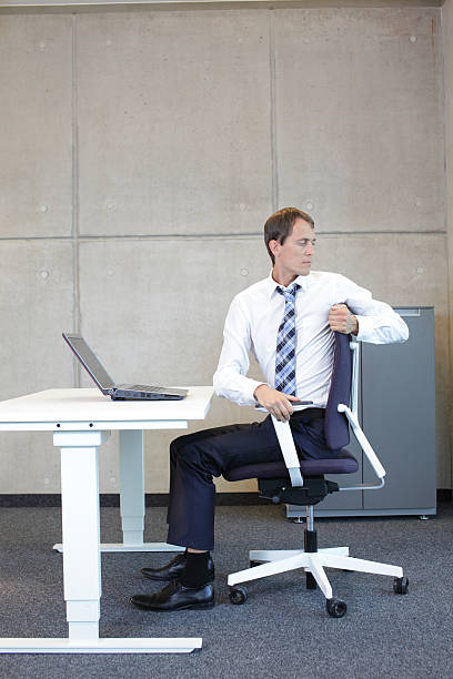 istock exercises in office. business man arm-neck stretching 528711327