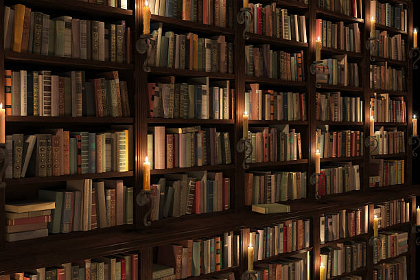 geheimnisvolle bibliothek mit kerzenbeleuchtung - book book spine in a row library stock-fotos und bilder