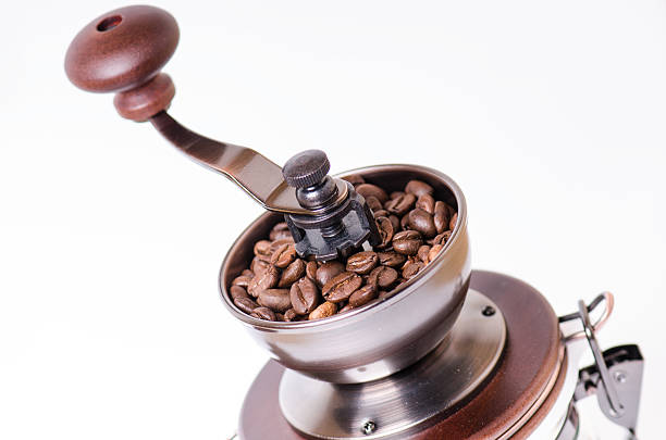 istock Manual coffee grinder with coffee beans. Isolated. White background. 528712074