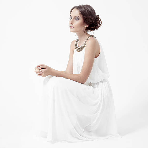 istock Young brunette woman in white dress. 528712449
