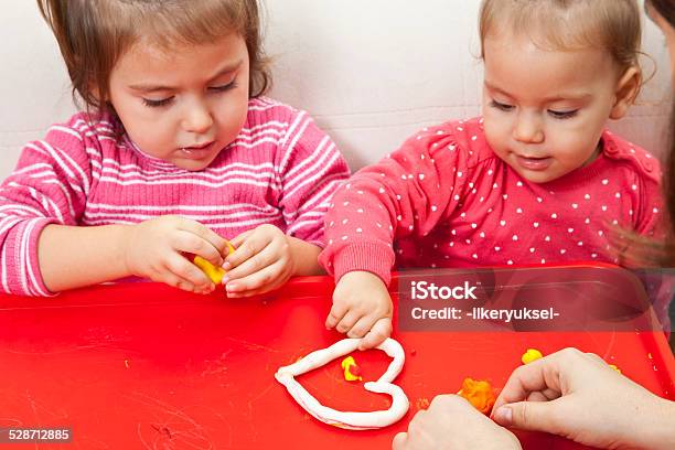 Girl Playing With Play Dough Stock Photo - Download Image Now - 12-17 Months, Activity, Art