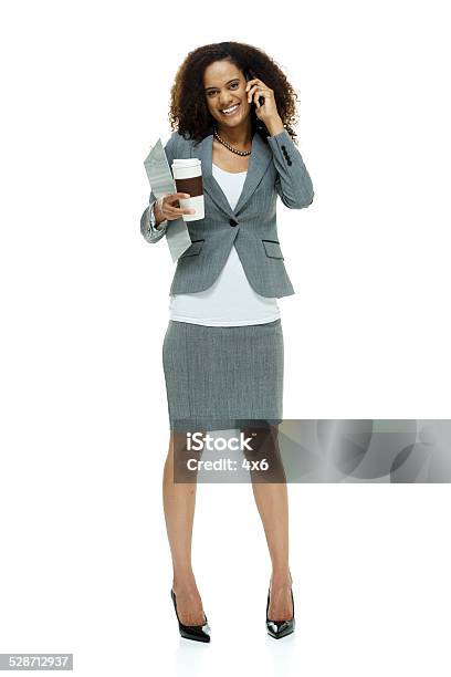 Happy Businesswoman On Mobile Holding Coffee Cup Stock Photo - Download Image Now - 20-29 Years, 25-29 Years, Adult