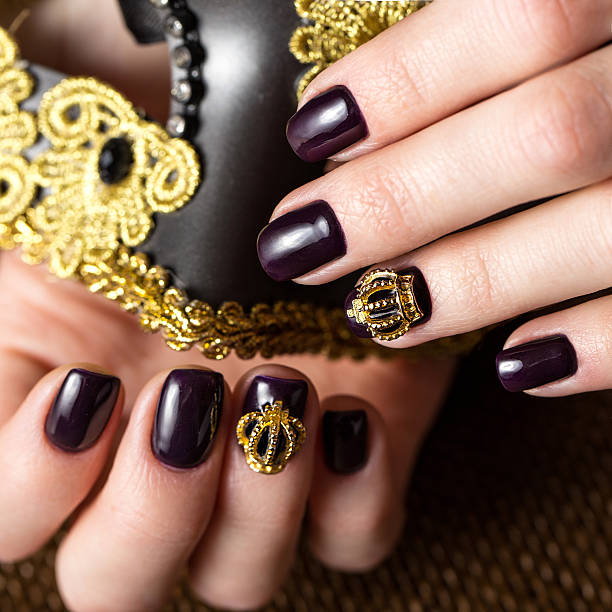 istock Black female manicure nails closeup with crown 528714622