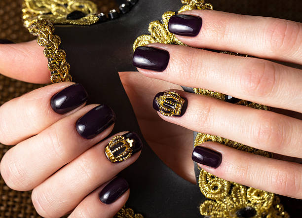 istock Black female manicure nails closeup with crown 528714666