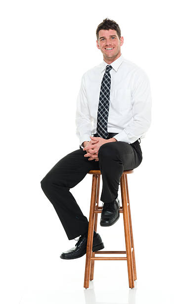 istock Smiling businessman sitting on stool 528718790