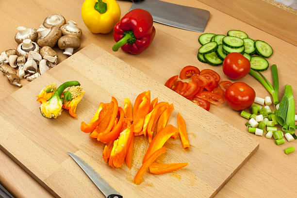 istock Freshly cleaned and sliced orange bell pepper on chopping board 528719940