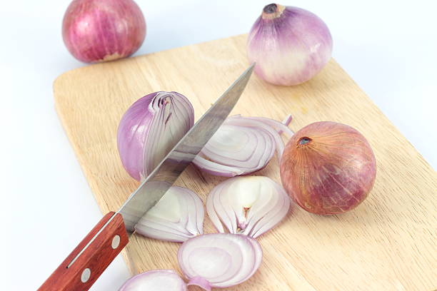 istock Turned red onions on a wooden cutting board 528720858