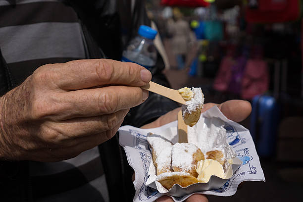 istock Man eating poffertjes in Amsterdam 528722854