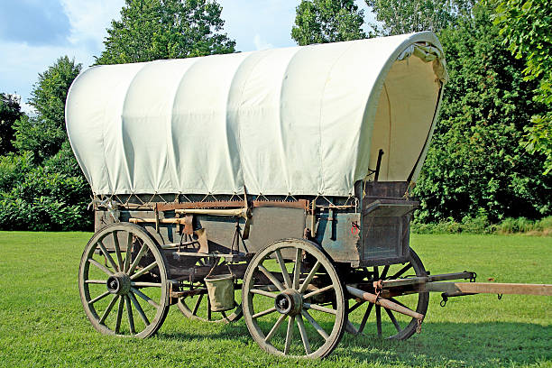 Covered Wagon Covered wagon with a beautiful landscape background. covered wagon stock pictures, royalty-free photos & images