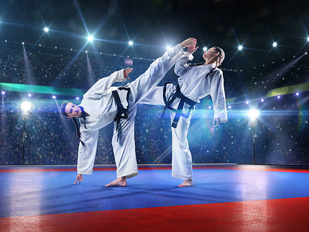 Two professional female karate fighters are fighting on the grand arena