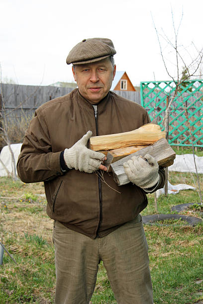 istock Country man with firewood 528724453