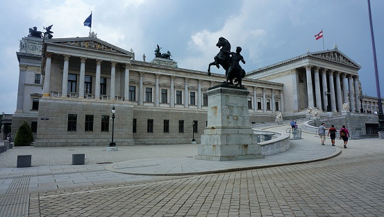 Vienna, Austria, 29th July 2014: the Austrian Parliament building mid-afternoon, with a small number of visitors approaching the building