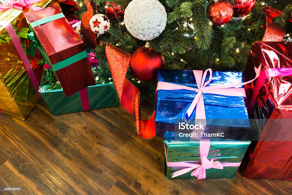 Christmas presents and gifts under the tree Christmas presents with christmas tree background ideal as backdrop and or placard Blue Stock Photo