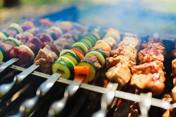 istock Meat and vegetable skewers on grill in nature 528725146