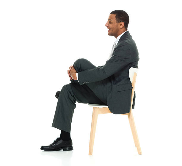 istock Smiling businessman sitting on chair 528725744
