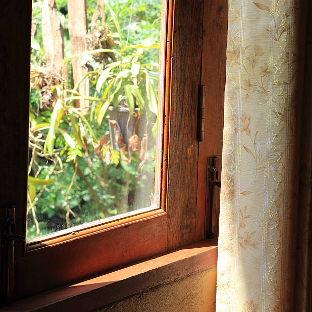 istock curtain at the window in morning 528725767