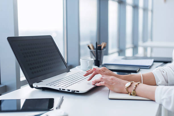istock Female worker using laptop in office, working with new project 528725790