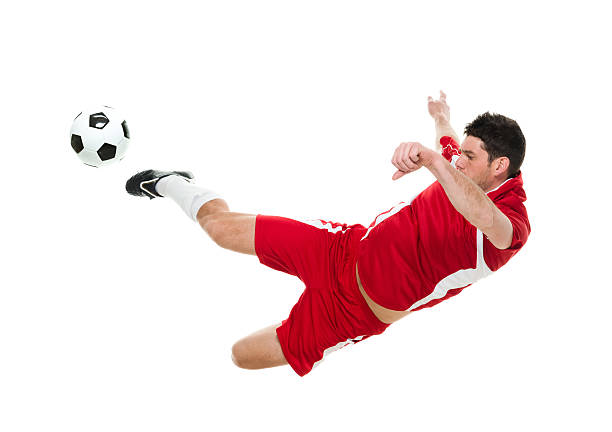 istock Soccer player jumping and kicking the ball 528725846