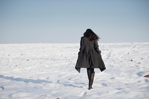 beautiful girl alone in winter snowy field