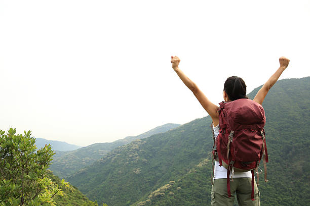 istock cheering woman hiker enjoy the view on mountain peak 528728074