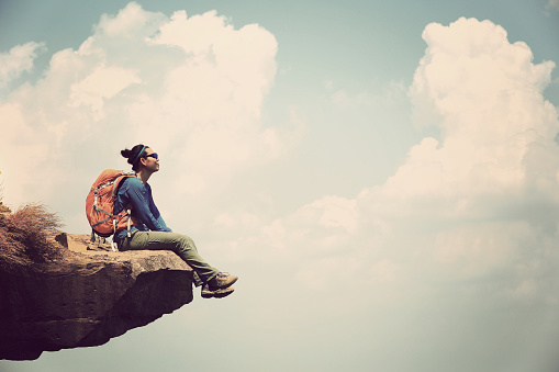 young asian woman enjoy the view at  mountain peak