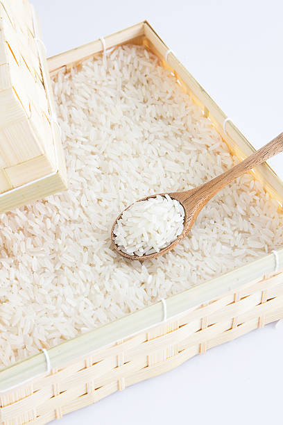 istock Raw and uncooked rice in wooden spoon. 528728838