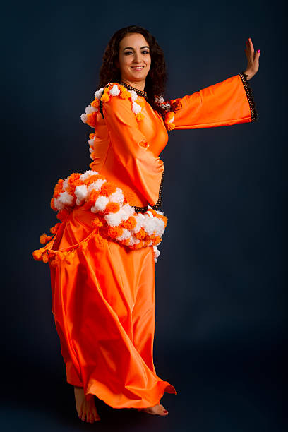 istock dancer posing in traditional orange costume 528729739