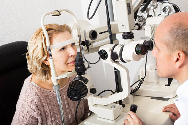 istock Optician doing eye check up to woman 528735164